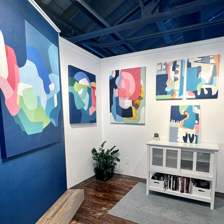 Art studio full of vibrant colorful and optimistic paintings by Adriana Ameigh Visions in Color 2022